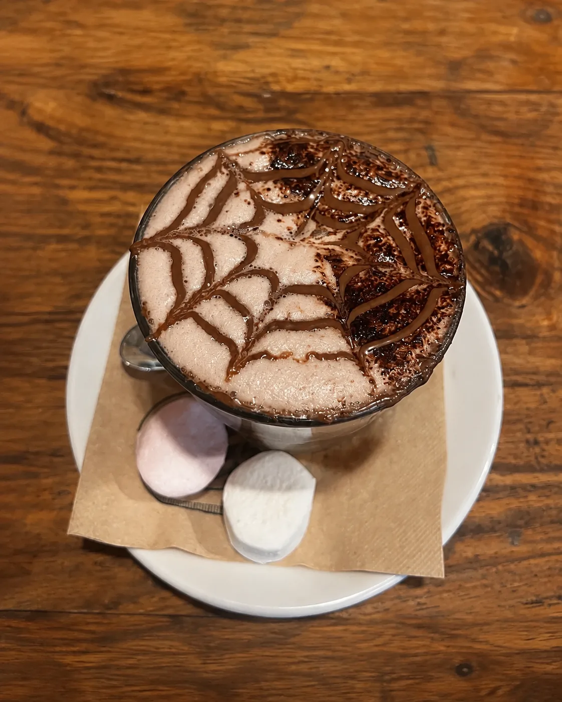 A chocolate drink on a wooden table at Grindz Cafe
