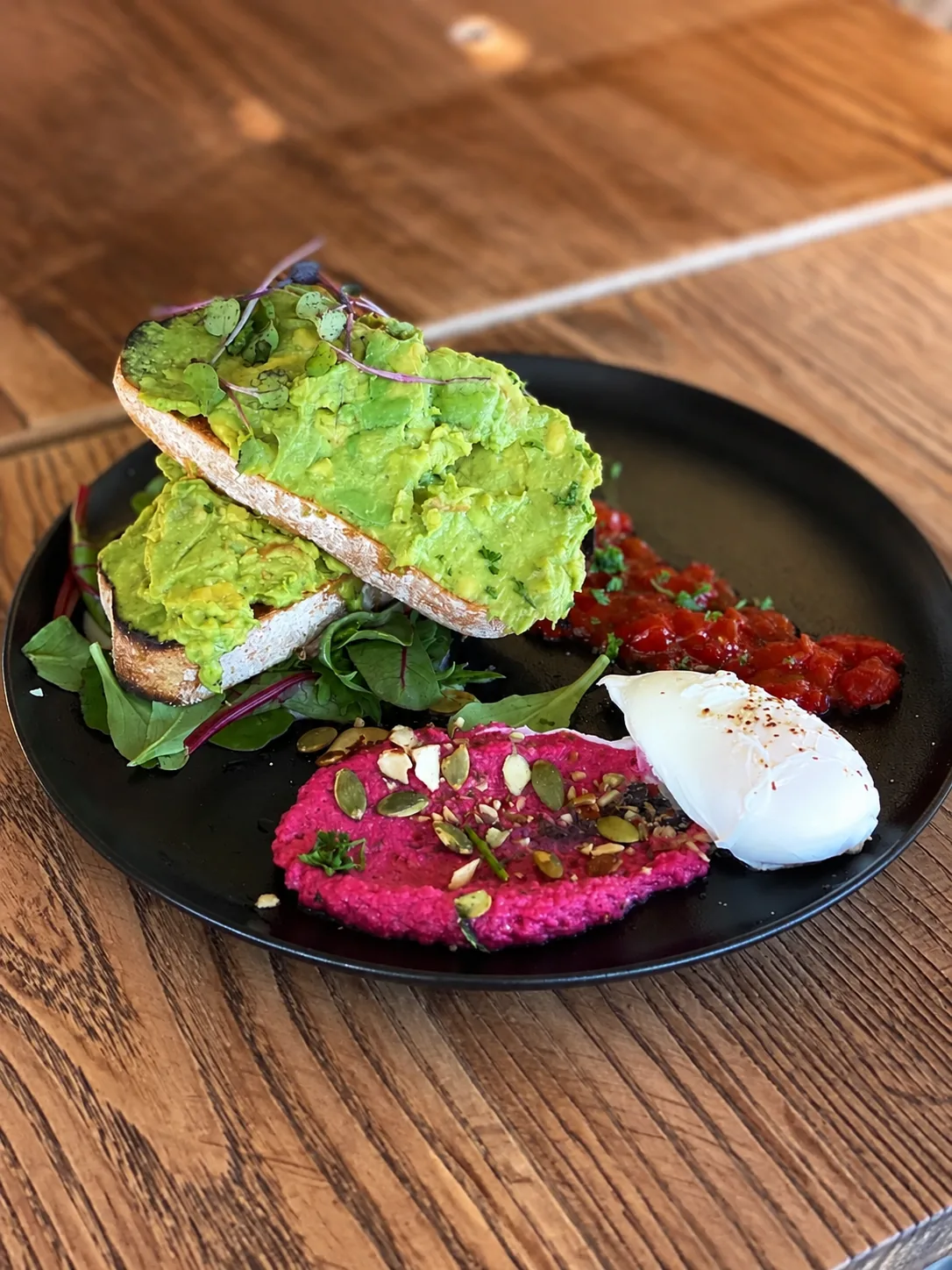 Avocado toast with greens, egg and beetroot spread